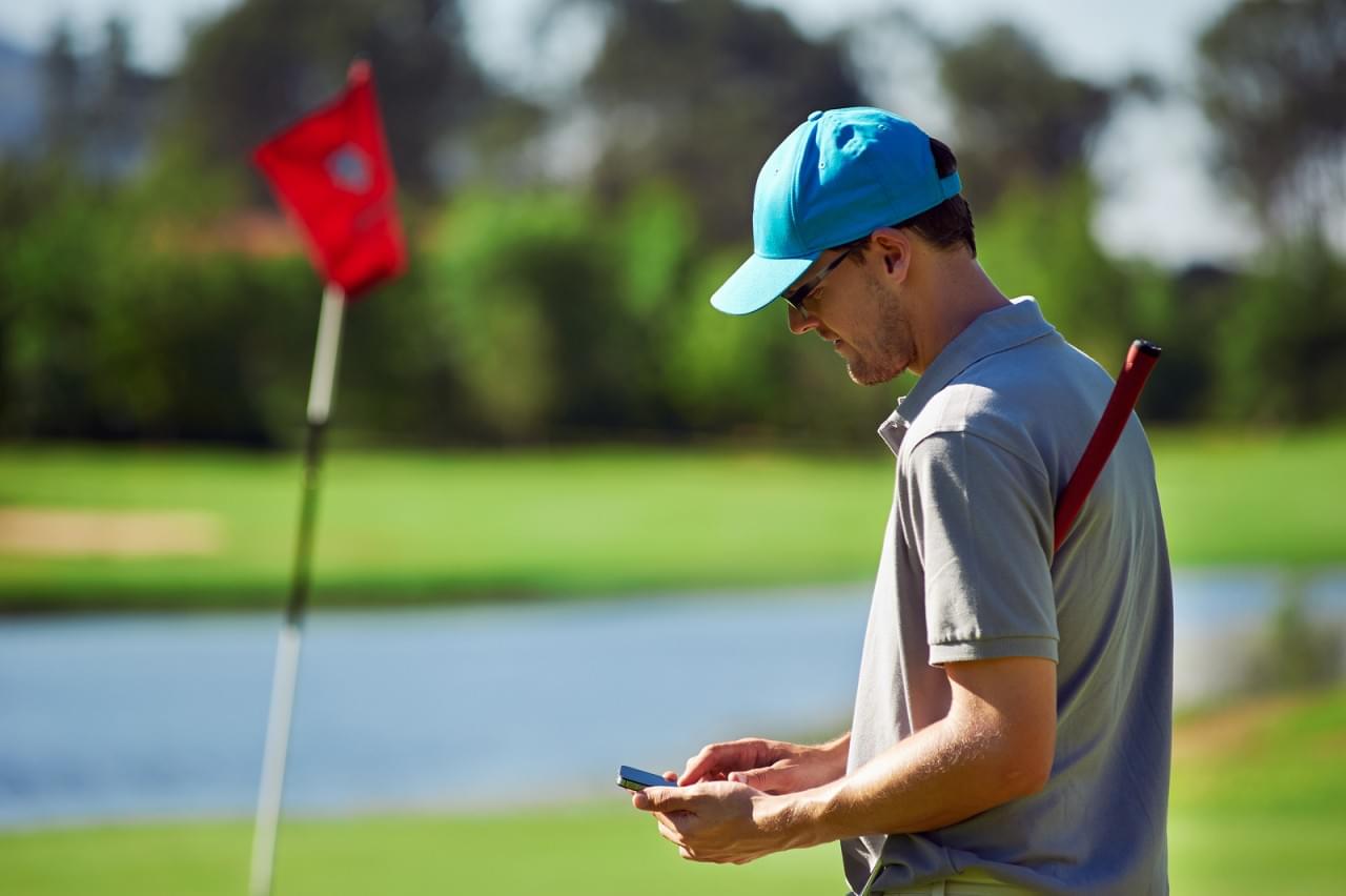 Golfer with smart phone Golfer with smart phone